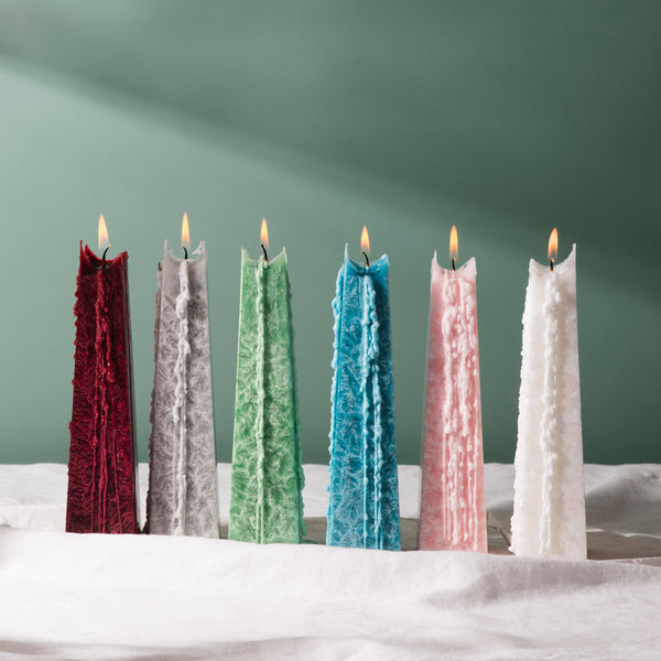 a line of multi coloured soy wax mini icicle candles