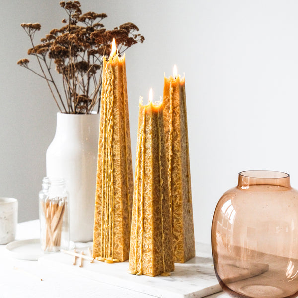 Living Light White Lily Icicle Candles glowing with delicate drip effect, styled with dried florals, match jar, and soft neutral-toned decor.